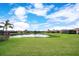 Expansive backyard with lush lawn and scenic pond view in a serene neighborhood at 6914 Quiet Creek Dr, Bradenton, FL 34212