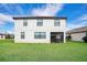 Home's backyard has a covered lanai with a dining set and a large grass lawn at 6914 Quiet Creek Dr, Bradenton, FL 34212