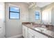 Bright bathroom with double vanity, granite countertops, and a large mirror at 6914 Quiet Creek Dr, Bradenton, FL 34212