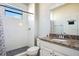 Bright bathroom features walk in shower with glass door, granite vanity and tile flooring at 6914 Quiet Creek Dr, Bradenton, FL 34212