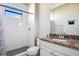 Bathroom featuring a walk-in shower with stone floors, granite countertops and white vanity at 6914 Quiet Creek Dr, Bradenton, FL 34212
