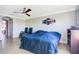 Spacious bedroom featuring a ceiling fan, tile flooring and natural light from the window at 6914 Quiet Creek Dr, Bradenton, FL 34212