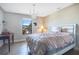 Cozy bedroom with a chandelier, a comfortable bed, and a large window for natural light at 6914 Quiet Creek Dr, Bradenton, FL 34212