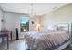 Cozy bedroom with a chandelier, a comfortable bed, and a large window for natural light at 6914 Quiet Creek Dr, Bradenton, FL 34212