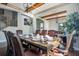 Inviting dining room with a long wooden table set for a meal with a staircase view and living room backdrop at 6914 Quiet Creek Dr, Bradenton, FL 34212