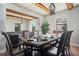 Elegant dining room with wood beam ceiling, dark wood furnishings and chandelier lighting at 6914 Quiet Creek Dr, Bradenton, FL 34212