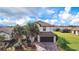 Stunning exterior view of a two-story home featuring a tile roof, attached garage, and vibrant landscaping at 6914 Quiet Creek Dr, Bradenton, FL 34212