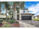 Beautiful two-story home with a two-car garage, tile roof, brick paver driveway, and lush landscaping at 6914 Quiet Creek Dr, Bradenton, FL 34212