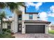 Charming home featuring beautiful front lawn with brick driveway that leads to the attached dark garage at 6914 Quiet Creek Dr, Bradenton, FL 34212