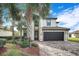 Charming two-story house with a tile roof, brown two car garage and neatly manicured landscaping at 6914 Quiet Creek Dr, Bradenton, FL 34212