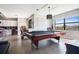 Spacious game room with a large pool table, bar area, and bright natural light at 6914 Quiet Creek Dr, Bradenton, FL 34212
