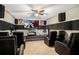 A cozy home theater includes reclining chairs, a large screen, and acoustic dampening for a relaxing movie experience at 6914 Quiet Creek Dr, Bradenton, FL 34212