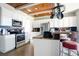 Well-lit kitchen featuring stainless steel appliances, granite countertops, and white cabinetry at 6914 Quiet Creek Dr, Bradenton, FL 34212