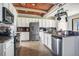 A spacious kitchen with stainless appliances, granite counters, and a butcher block style wooden ceiling at 6914 Quiet Creek Dr, Bradenton, FL 34212