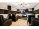 Comfortable media room equipped with plush seating, a ceiling fan, and a large screen at 6914 Quiet Creek Dr, Bradenton, FL 34212