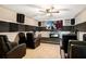 Cozy home theater featuring tiered seating, a large screen, and optimal acoustics at 6914 Quiet Creek Dr, Bradenton, FL 34212