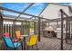 This outdoor deck includes colorful seating and a cooking area with a grill and pizza oven at 8922 Pritcher Rd, Lithia, FL 33547