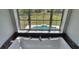 Bathtub with a large picture window overlooking a lush backyard and sparkling swimming pool at 8922 Pritcher Rd, Lithia, FL 33547