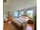 This spacious bedroom features wood floors, a large bed and lots of natural light from the windows at 8922 Pritcher Rd, Lithia, FL 33547