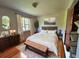 Comfortable bedroom with hardwood floors, natural light, a decorative dresser, and king bed at 8922 Pritcher Rd, Lithia, FL 33547
