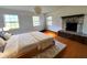 This bedroom features wood floors, an area rug and a decorative fireplace made of stone at 8922 Pritcher Rd, Lithia, FL 33547