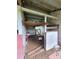 Interior of chicken coop with dirt floor, wooden beams, and small wooden shelf at 8922 Pritcher Rd, Lithia, FL 33547