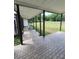 Spacious covered patio with brick flooring, providing an inviting outdoor living space with serene views at 8922 Pritcher Rd, Lithia, FL 33547