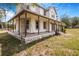 Charming two-story home with a stone chimney and inviting wrap-around porch at 8922 Pritcher Rd, Lithia, FL 33547