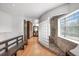 Hallway with wooden floors that features a bench seat, glass block wall, shower and unique architecture at 8922 Pritcher Rd, Lithia, FL 33547
