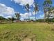 Beautiful two-story home with a large grassy yard surrounded by trees and wooden fence at 8922 Pritcher Rd, Lithia, FL 33547