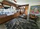 Unique kitchen design with dark countertops, stainless steel appliances, and a farmhouse sink at 8922 Pritcher Rd, Lithia, FL 33547
