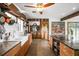 Rustic kitchen featuring custom wood cabinetry, a farmhouse sink, and modern appliances at 8922 Pritcher Rd, Lithia, FL 33547