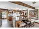 Spacious kitchen with a sizable island, wood beams, custom cabinetry and ample counter space at 8922 Pritcher Rd, Lithia, FL 33547