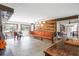 Open-concept living room with a wood accent wall and access to the backyard at 8922 Pritcher Rd, Lithia, FL 33547