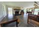 Inviting living room with stone fireplace and grand piano near the outdoor pool at 8922 Pritcher Rd, Lithia, FL 33547