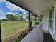 Spacious covered porch featuring brick-paved flooring overlooking the expansive green yard at 8922 Pritcher Rd, Lithia, FL 33547