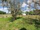 Expansive green pastures surround a fenced yard with a barn and shed at 8922 Pritcher Rd, Lithia, FL 33547