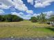 Expansive green pastures surrounded by a wooden fence under a blue sky at 8922 Pritcher Rd, Lithia, FL 33547