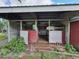 Shed with stalls and doors, surrounded by some overgrowth at 8922 Pritcher Rd, Lithia, FL 33547