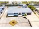 Aerial view of the home showcasing its fresh landscaping, updated paint, and spacious driveway at 1046 Lee St, Englewood, FL 34224