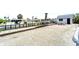 View of backyard including canal, dock and small shed at 1046 Lee St, Englewood, FL 34224