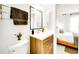 Modern bathroom with wood vanity, stainless steel fixtures, and towel rack at 1046 Lee St, Englewood, FL 34224