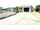 Well-maintained single-story home featuring a black two-car garage door and a concrete driveway at 1046 Lee St, Englewood, FL 34224