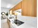Modern kitchen boasting white subway tile backsplash, white countertops, and ample wood cabinets at 1046 Lee St, Englewood, FL 34224