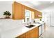 Bright kitchen with modern countertops, stainless steel appliances, and natural wood cabinets at 1046 Lee St, Englewood, FL 34224