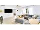 Bright and airy living room with neutral tones, a ceiling fan, and a large window at 1046 Lee St, Englewood, FL 34224