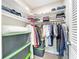 Organized walk-in closet featuring shelves, hanging rods, and storage containers at 1901 Upper Cove Ter, Sarasota, FL 34231