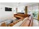 Bright living room featuring a stylish leather sofa, modern rug, and sliding glass doors leading to the outdoor area at 1901 Upper Cove Ter, Sarasota, FL 34231