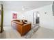 Cozy living room features a modern sectional sofa, ceiling fan, and doorway to another room at 1901 Upper Cove Ter, Sarasota, FL 34231