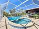 The inground pool features an attached spa within a screened-in enclosure, perfect for sunny days at 1901 Upper Cove Ter, Sarasota, FL 34231